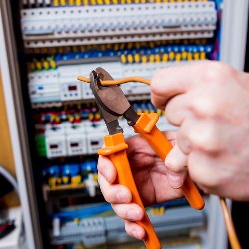 An Electrician Adjusts a Wire